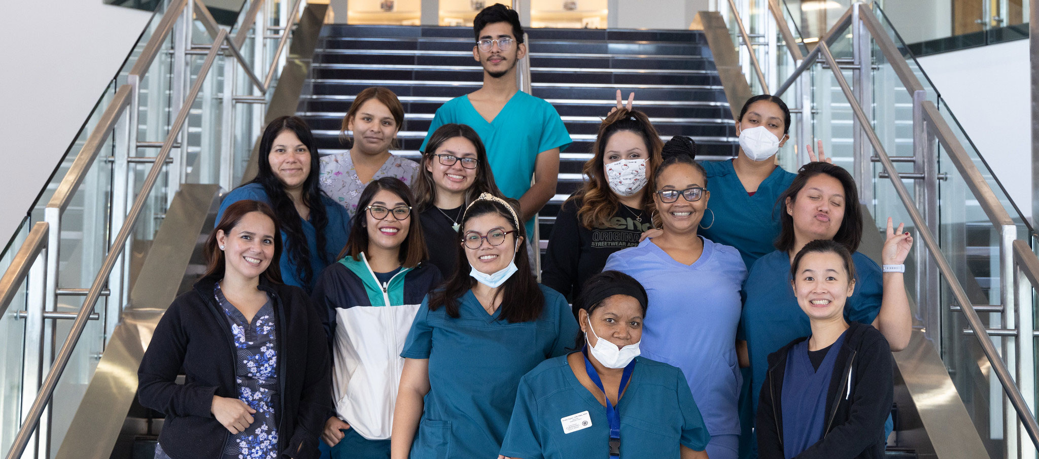 healthcare career pathways 13 healthcare students in scrubs take a group photo on stairs