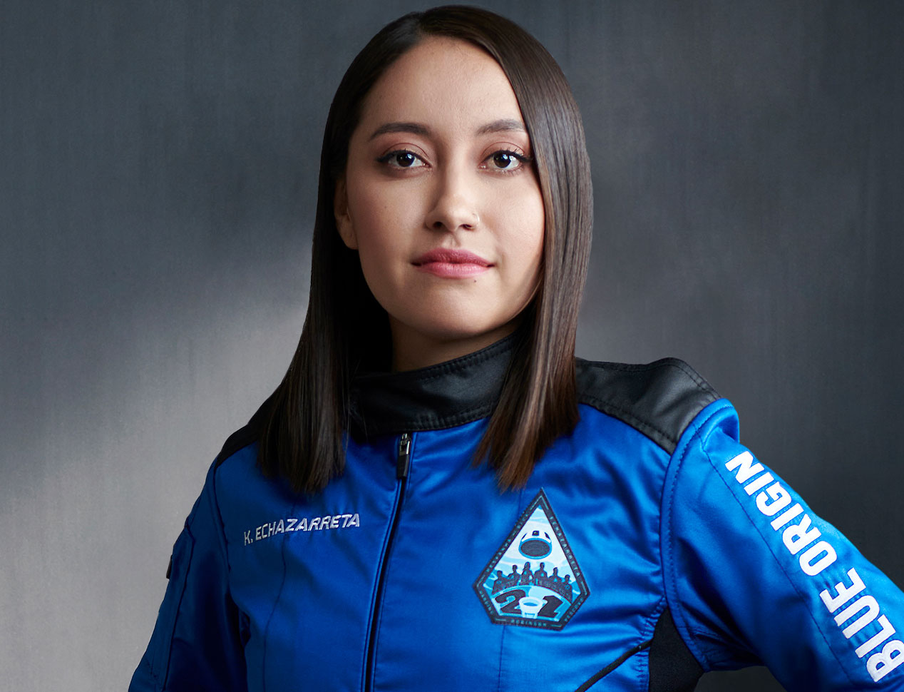 Katya is wearing a blue flight suit from the company Blue Origin