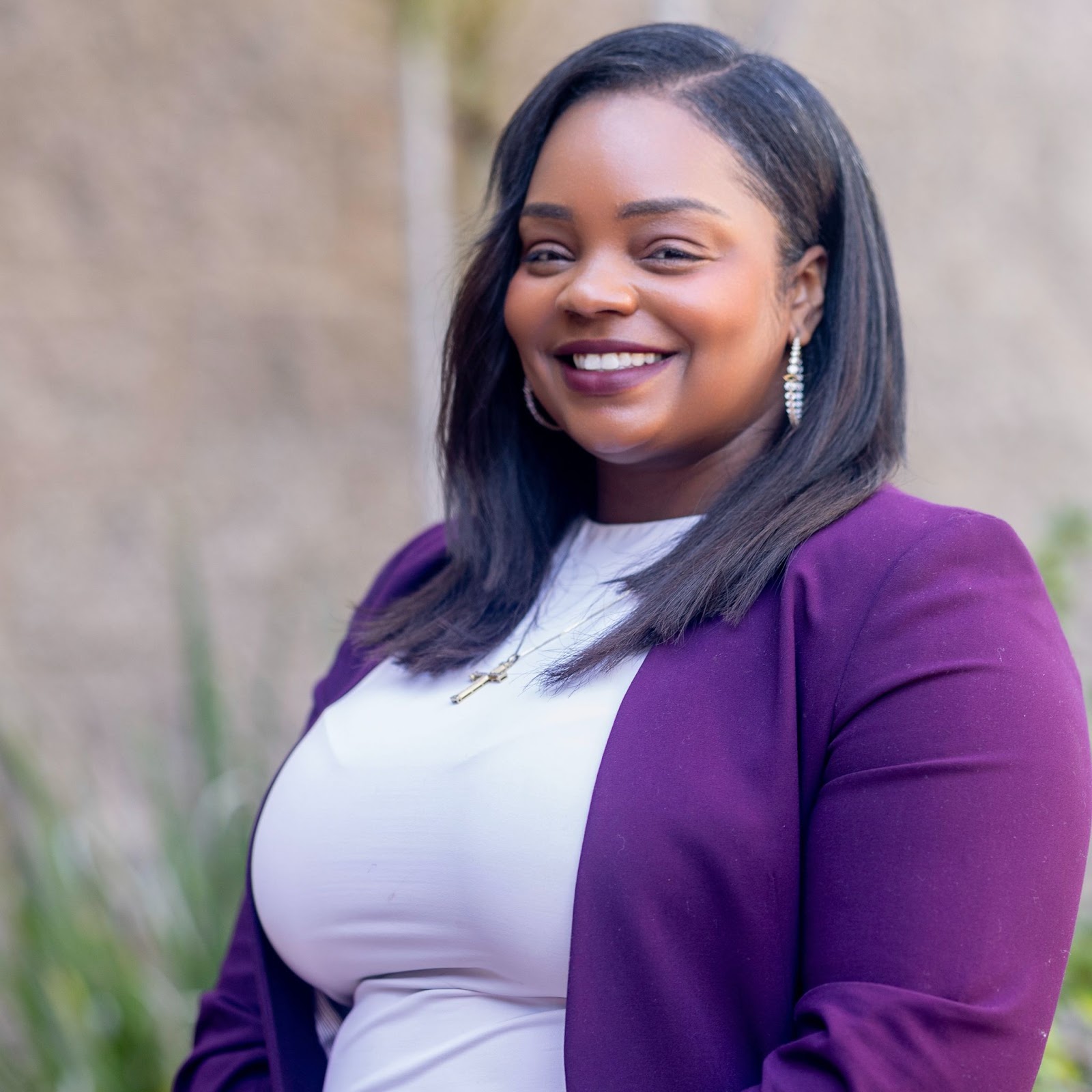 Shakerra Carter is wearing a white top and a purple blazer