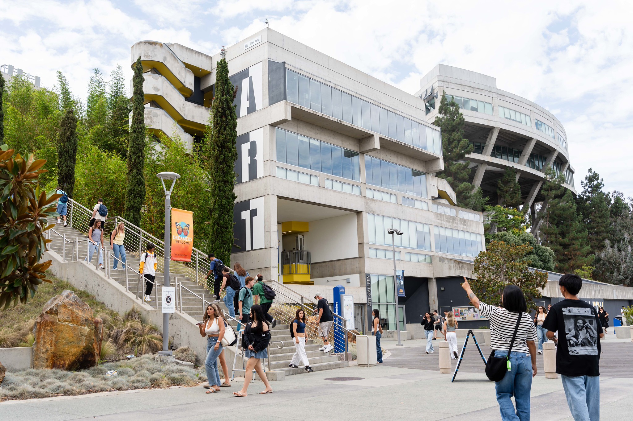 Students near a large staircase on Mesa College campus.