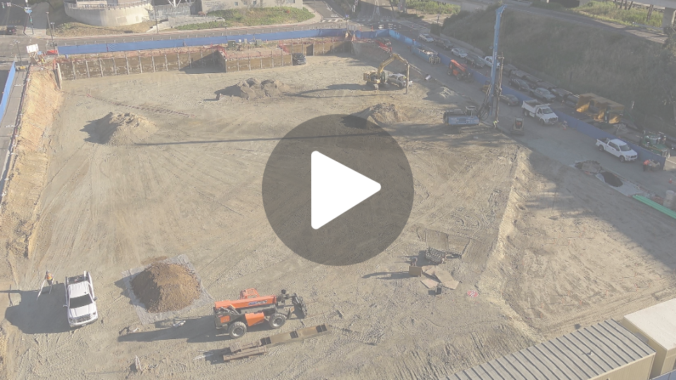 City College Affordable Housing Construction Camera Construction site primarily showing flat dirt with construction vehicles spread throughout the site working.