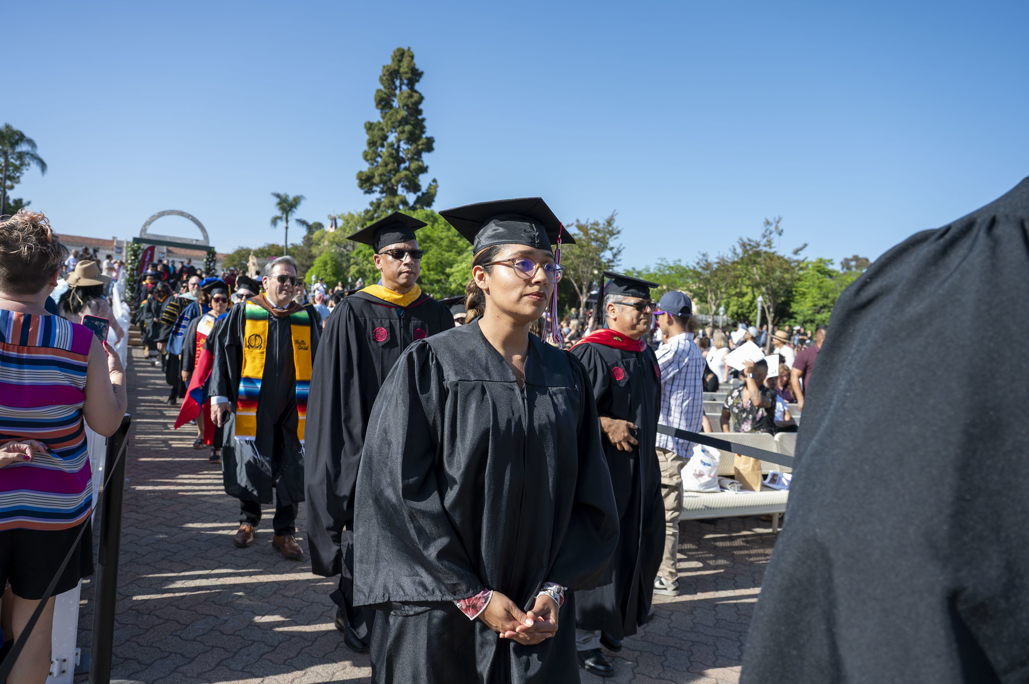 
City College faculty walking toward the stage.
