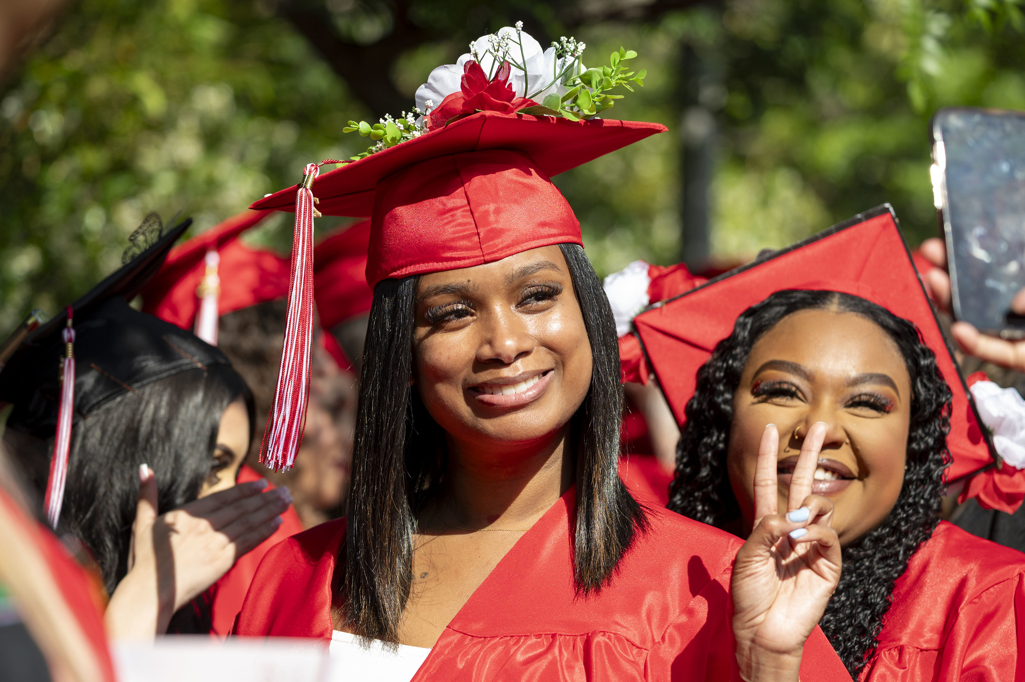 
A graduate gives a peace sign.
