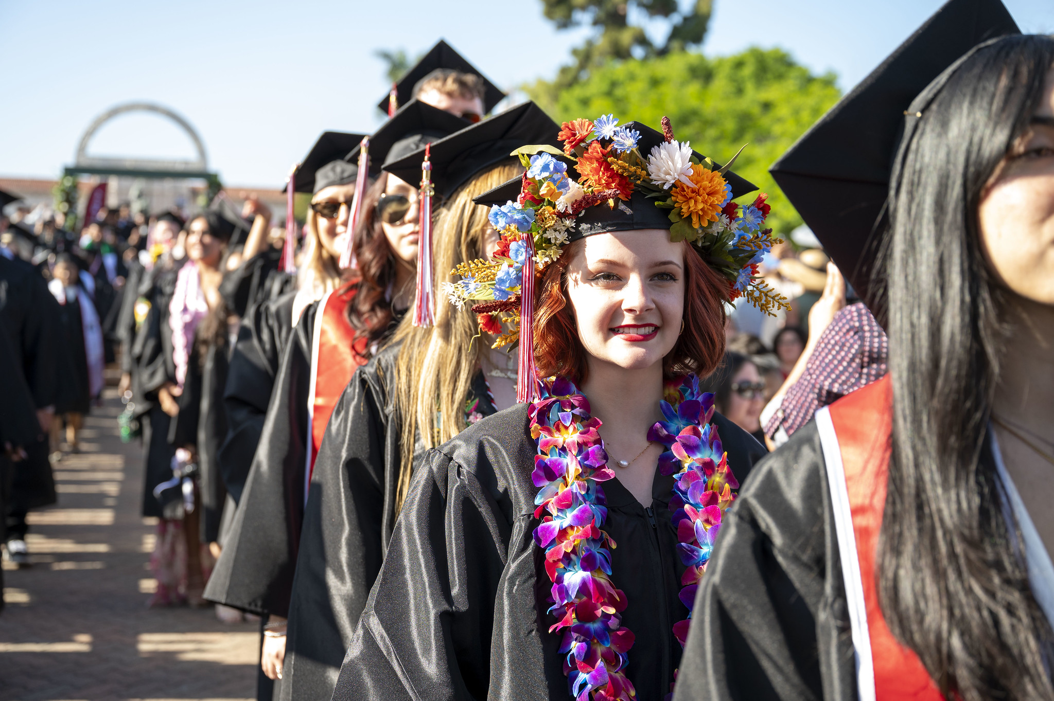 
A line of graduates heading toward the stage.
