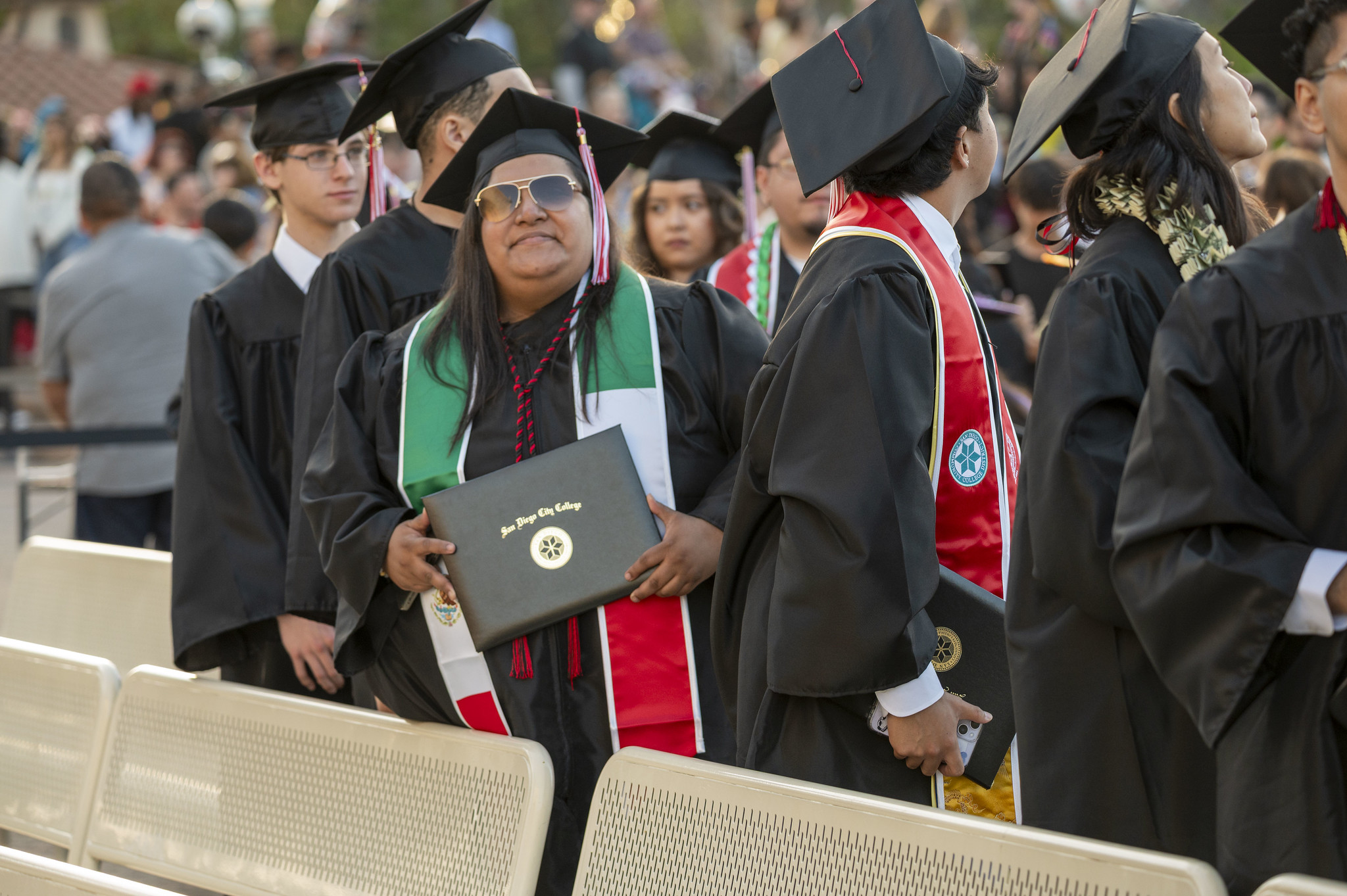 
A graduate holds up her degree.
