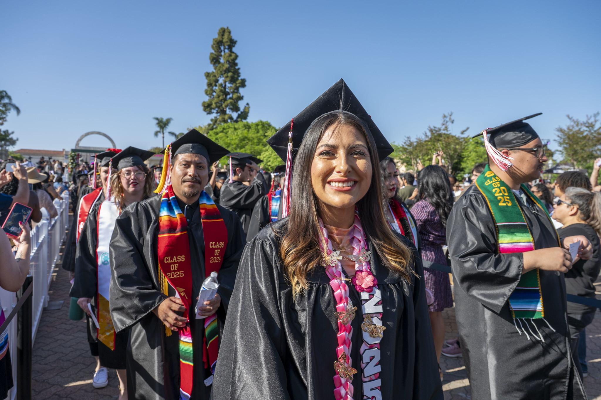 
Two lines of graduates enter the ceremony.
