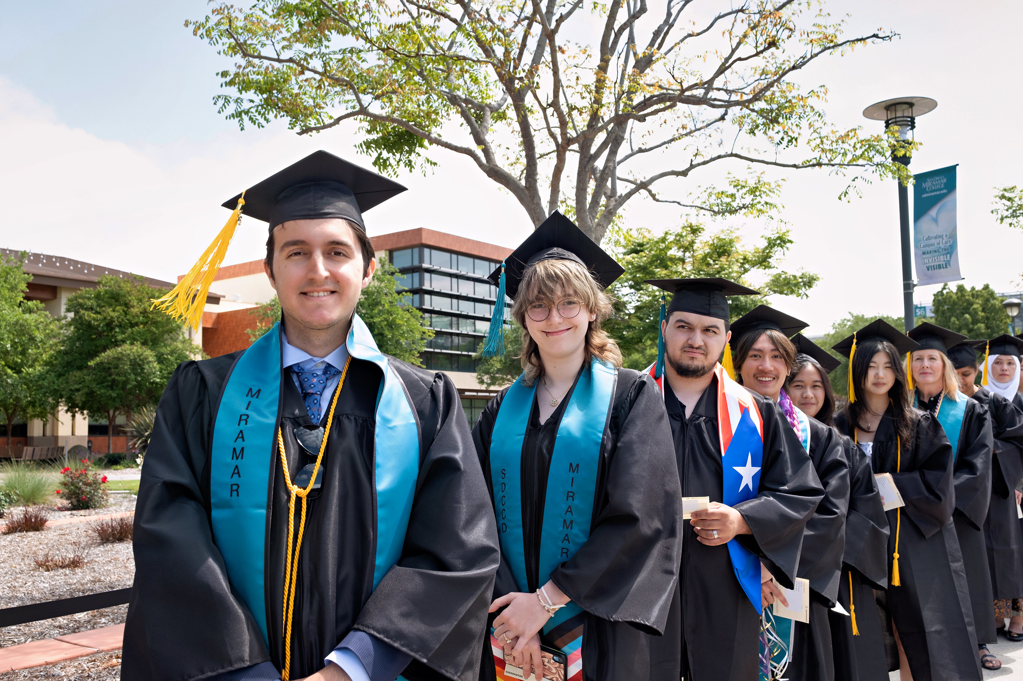 
Eight students line up to walk into commencement.
