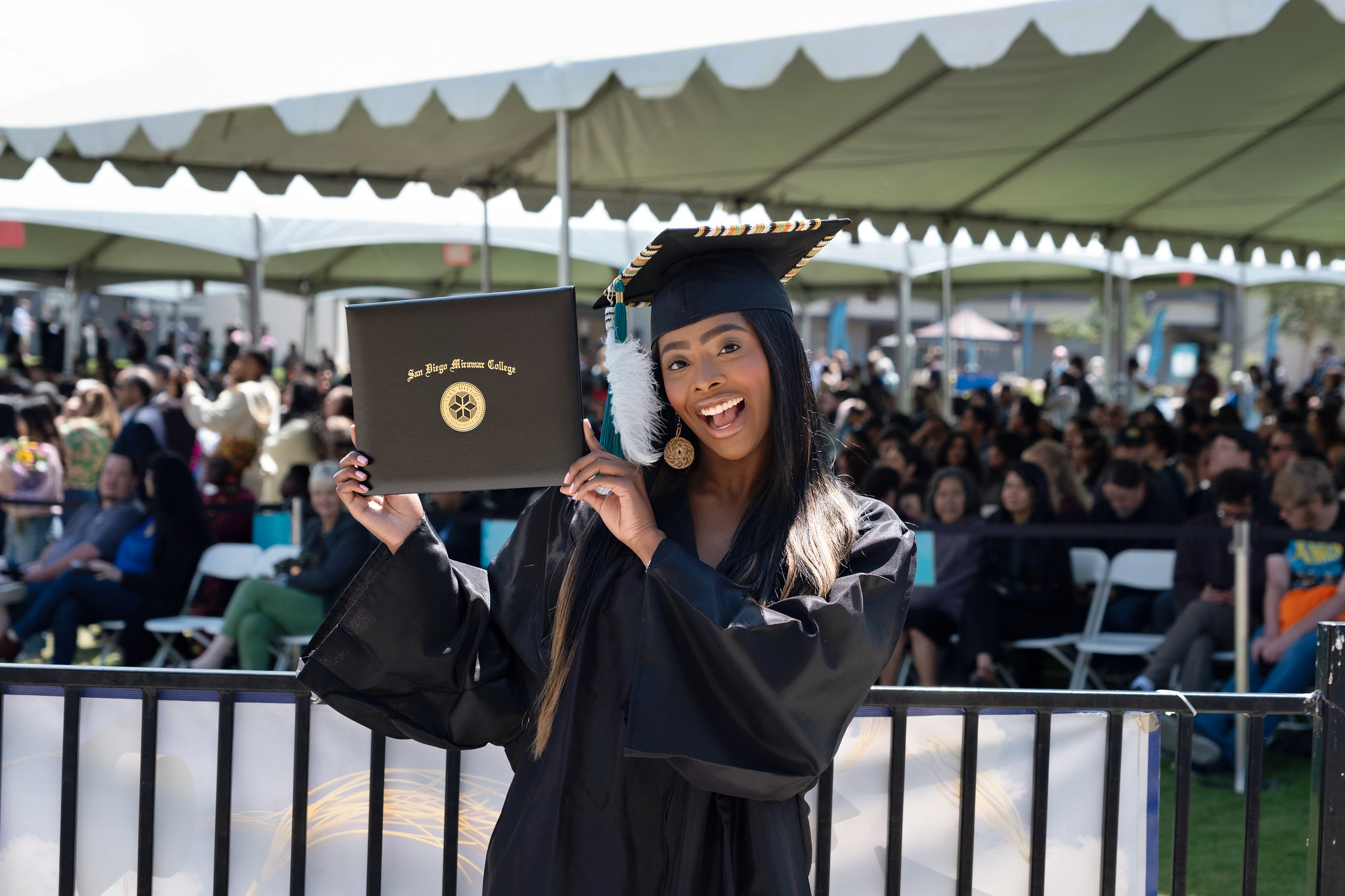 
A graduate holds up her degree.
