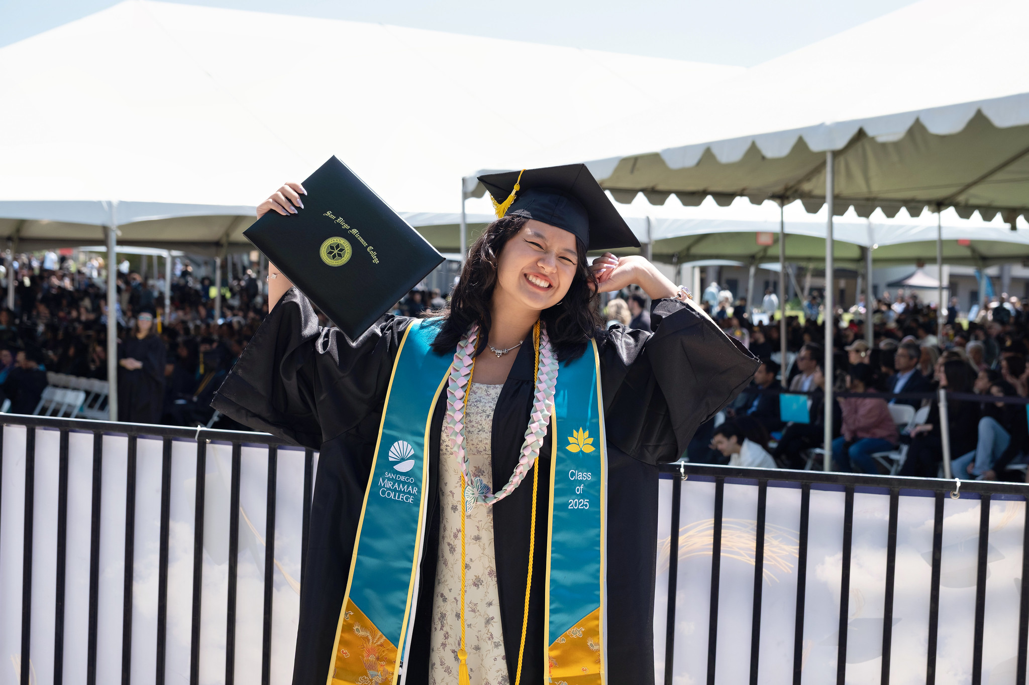 
A graduate holds up her degree.
