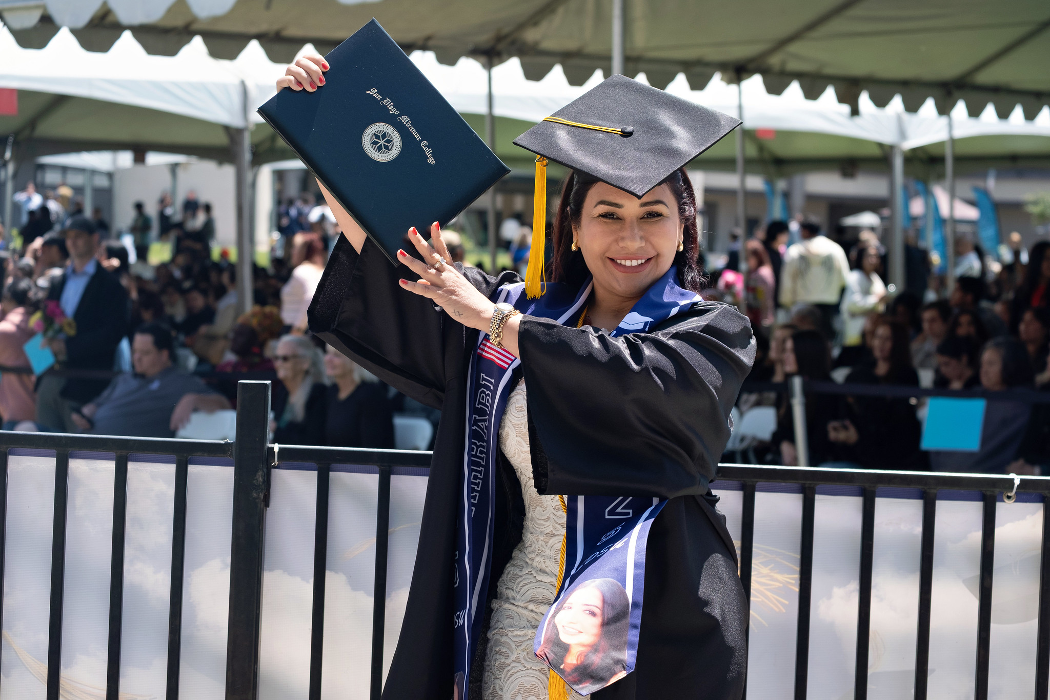 
A graduate holds up her degree.

