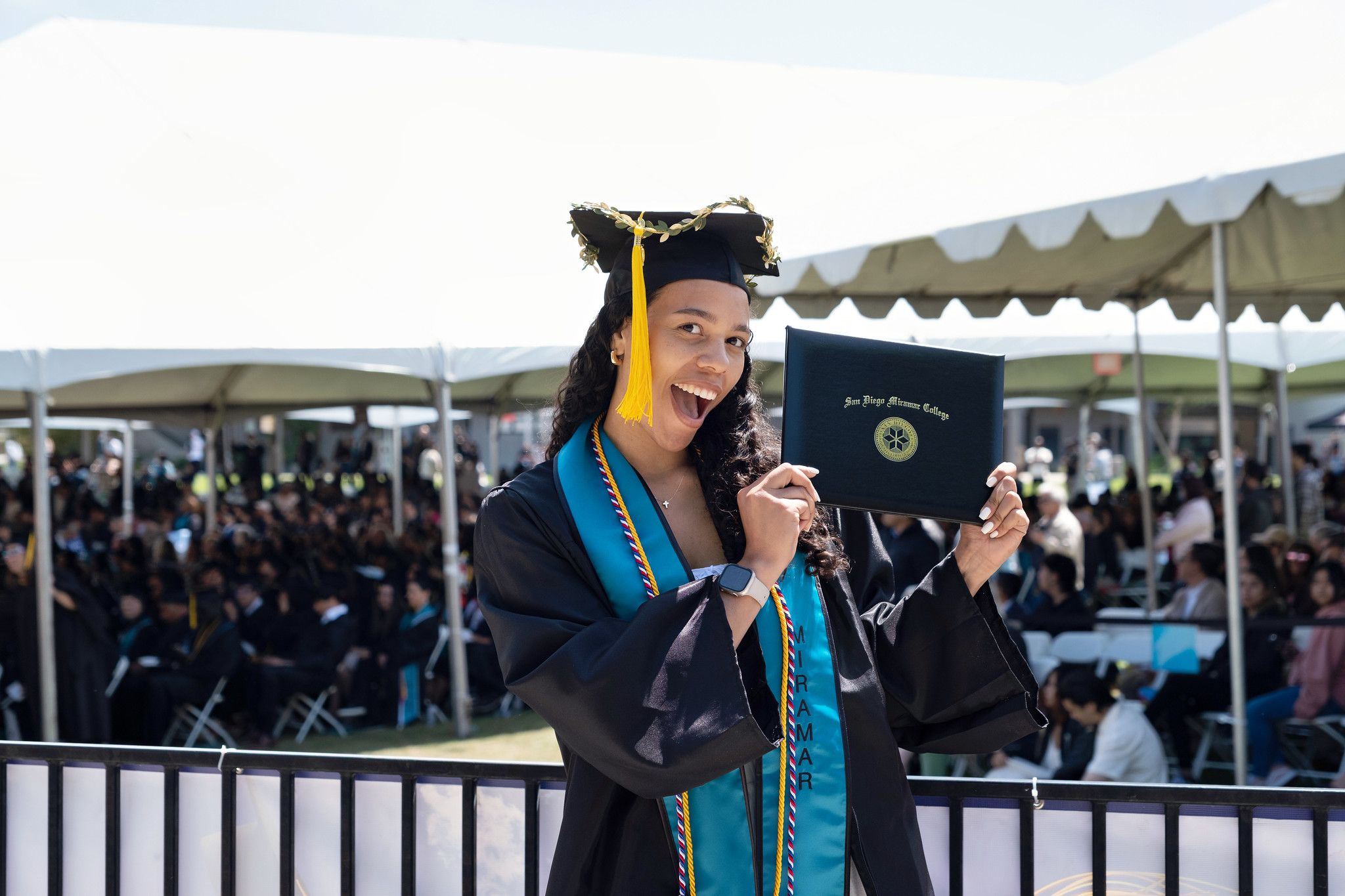 
A graduate holds up her degree.
