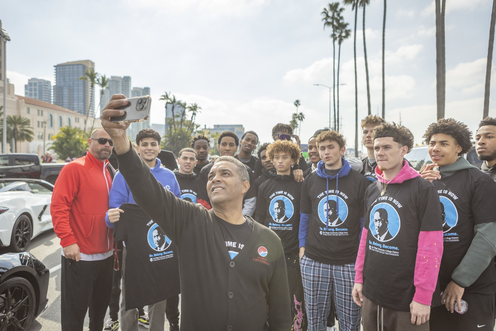 City College president Ricky Shabazz takes a selfie with about 20 student athletes.