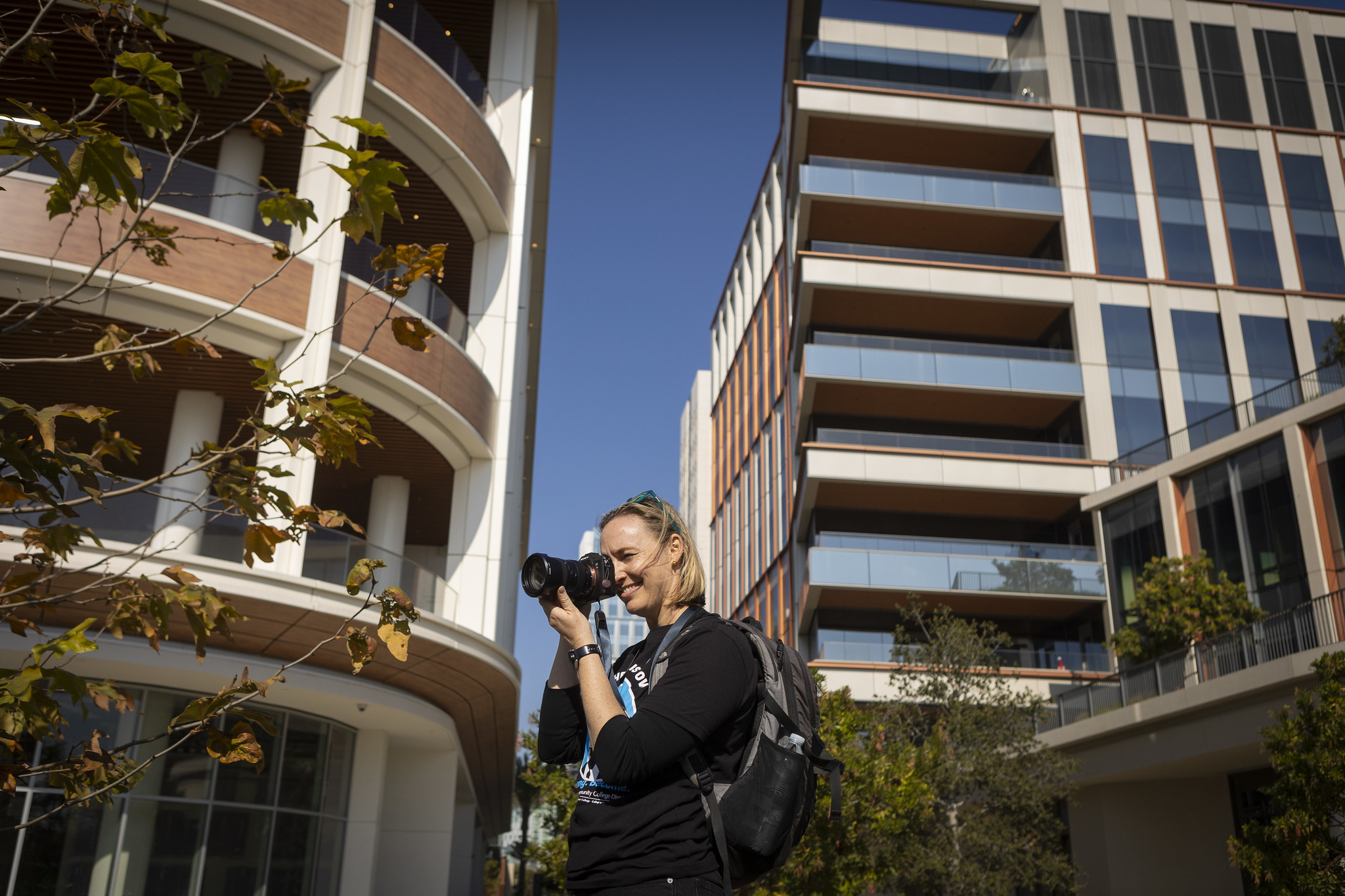 Manager of Creative Services Leslie Stump takes a photo of the parade going by.