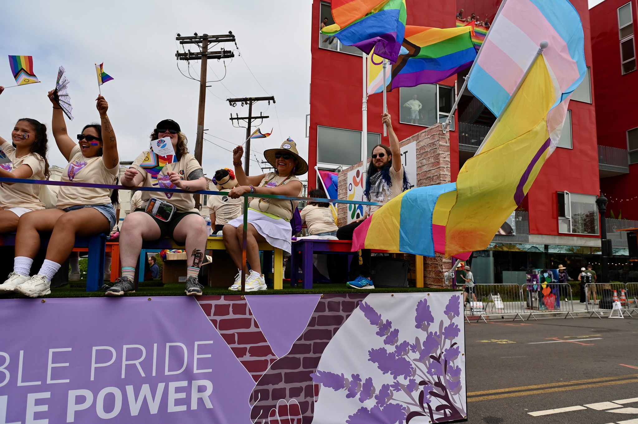 
People on the SDCCD float wave to the crowd.
