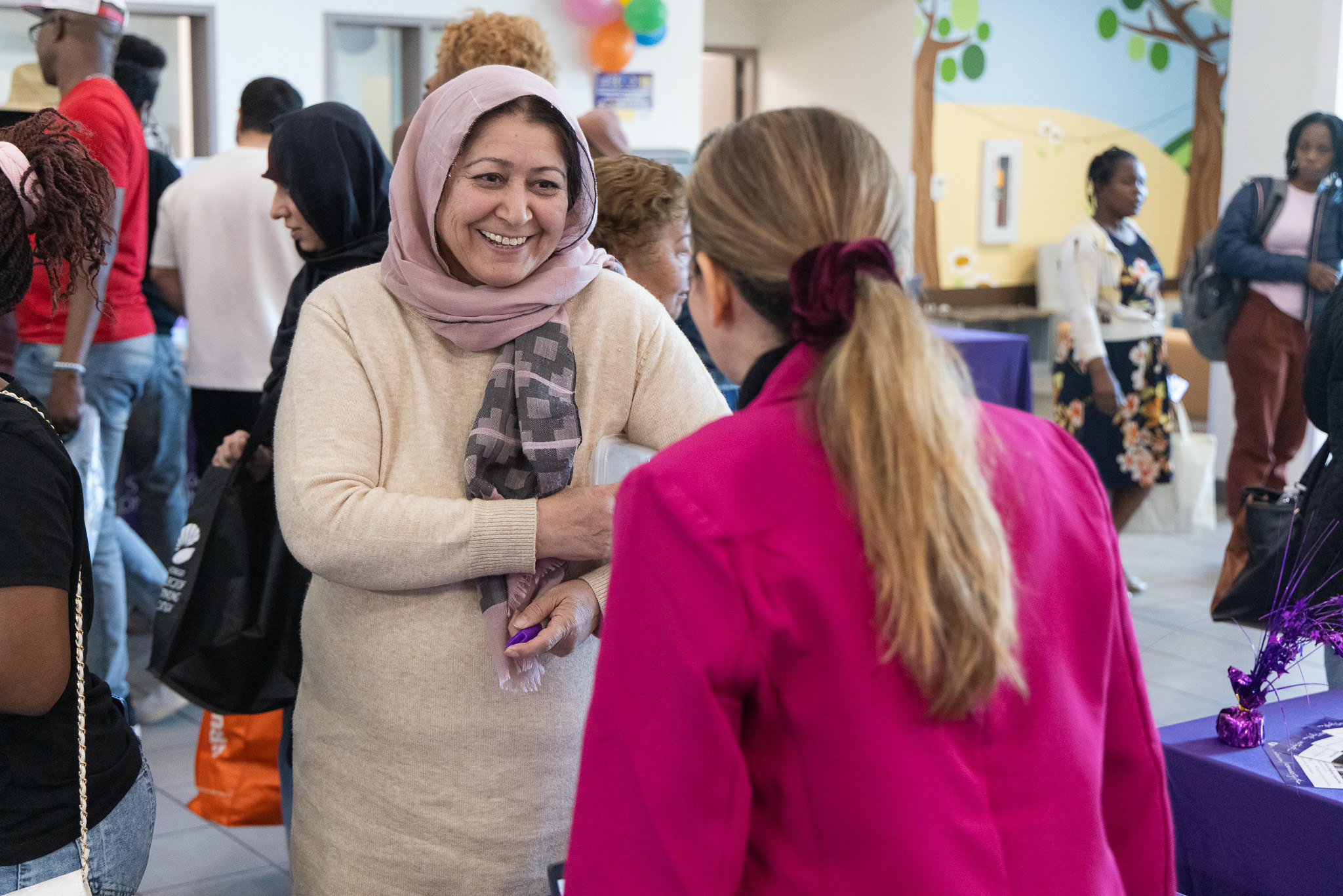 
Two ladies talking at a Continuing Education welcome event.
