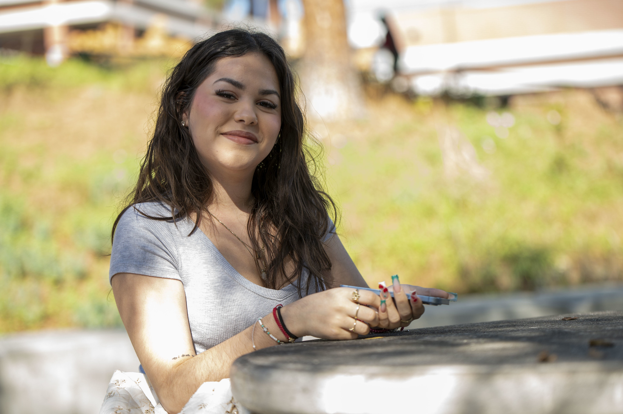 
A City student outside sitting at a table.
