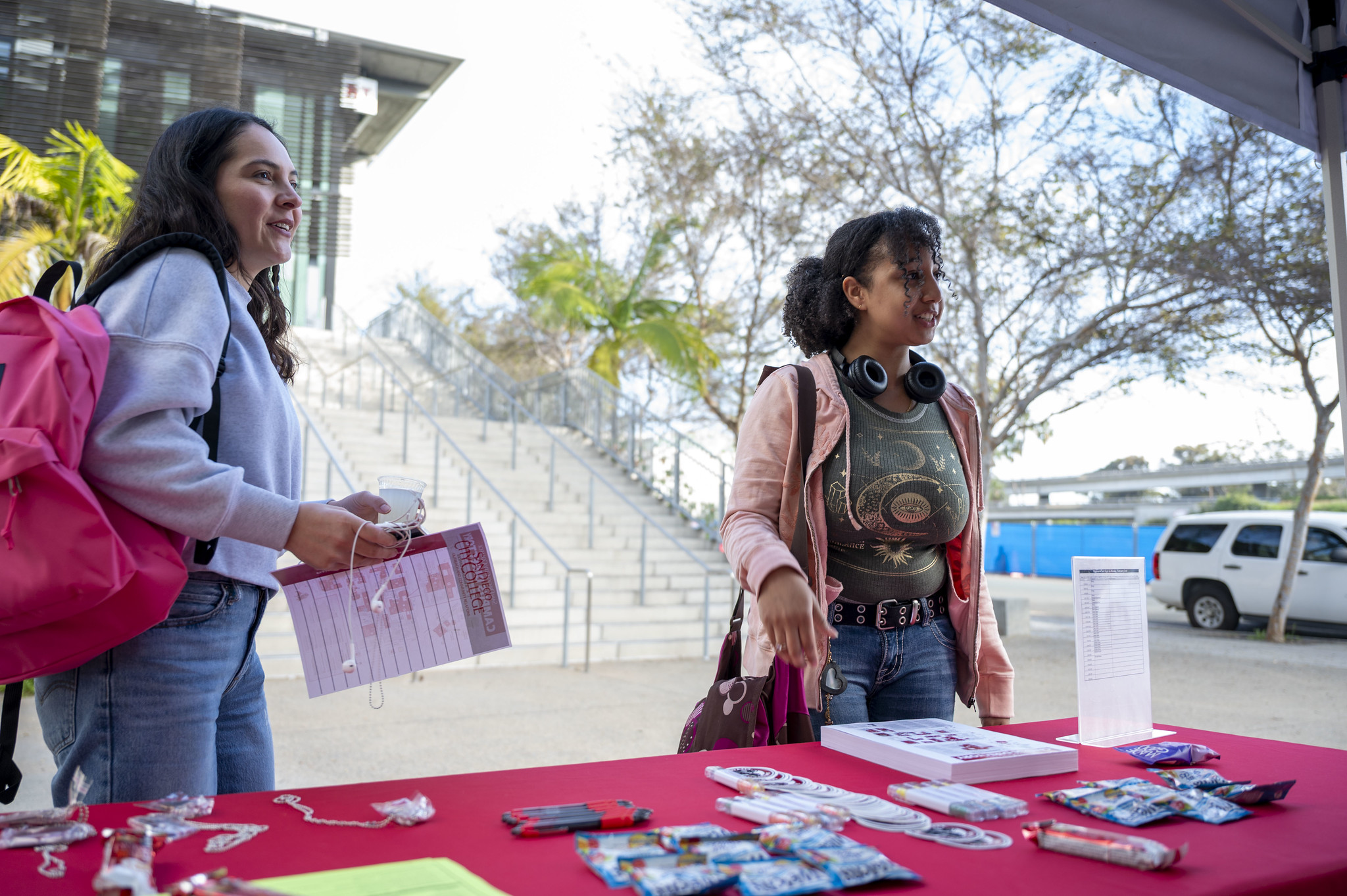 
Two students at a City College welcome table.
