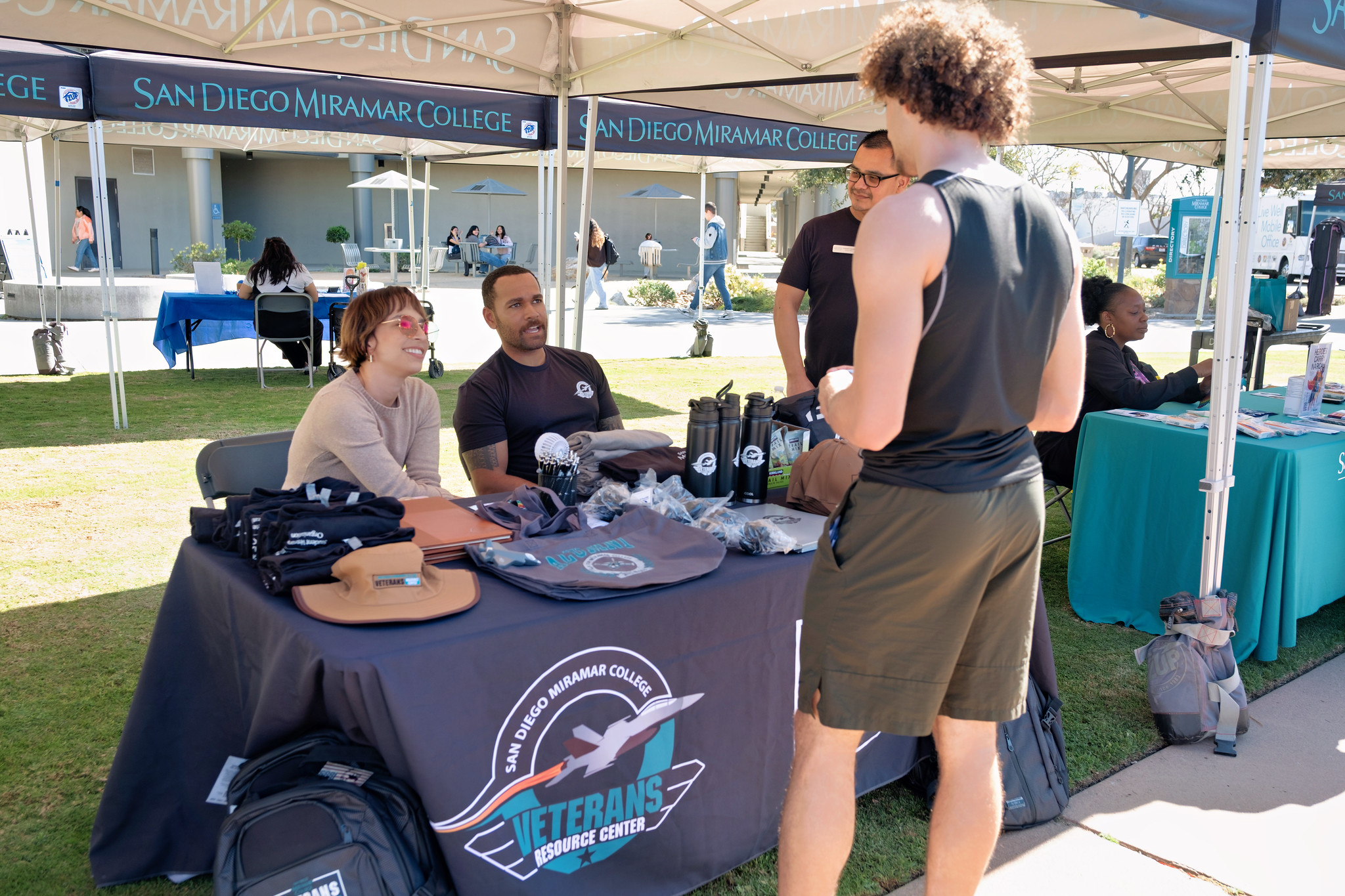 
A student stops at the Miramar Athletics welcom booth.
